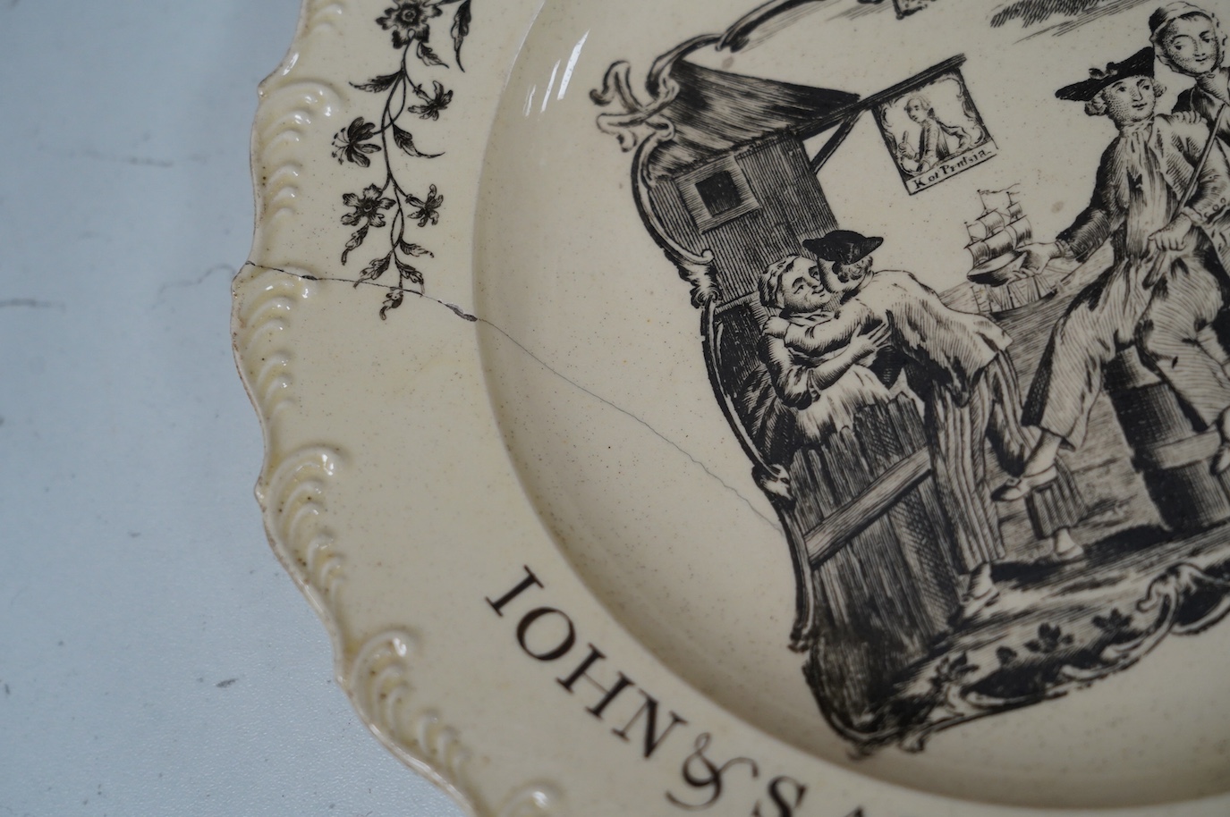 A George III documentary creamware plate, printed by Sadler, black enamelled inscription ‘John and Sarah Artis, Yarmouth 1769’, a further of example in the National Maritime Museum Greenwich (https://www.rmg.co.uk/collec